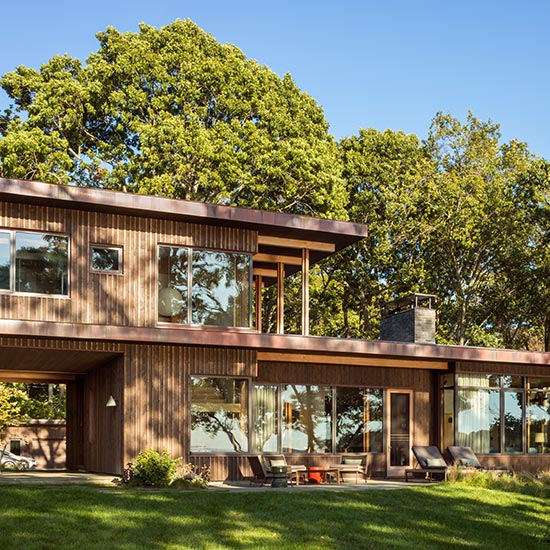 Passive house strategies, including a continuously insulated envelope, energy-recovery ventilation and a green roof, guided the design of this Long Island beach home.